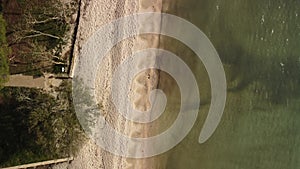 Sea water at springtime. Aerial top view of sandy beach and calm bay in spring
