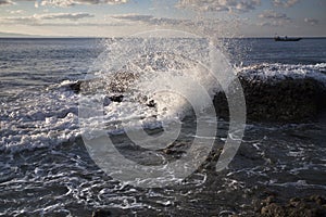 Sea water strikes a rock at the sea shore