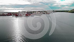 Sea water with sun path against harbor town aerial view