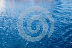 Sea water surface background. Calm blue water rippled with reflections