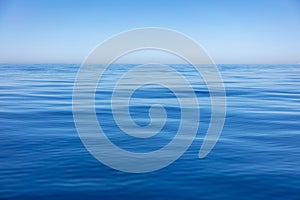 Sea water surface calm with small ripples. Still ocean, deep blue color background