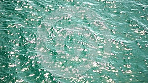 Sea water surface. Low angle view over clear azure sea water. Sun glare. Abstract nautical summer ocean nature. Holiday