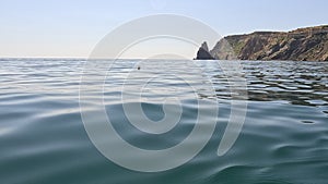 Sea water surface. Low angle view over clear azure sea water. Sun glare. Abstract nautical summer ocean nature. Holiday