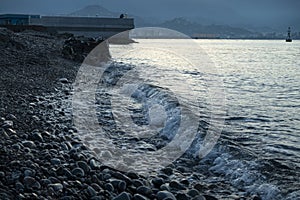 Sea water wave swash during blue hour photo