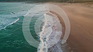 Sea water waves foaming sand closeup. Stormy ocean surf washing sandy beach