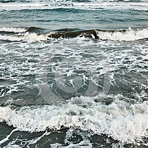 Sea water with waves and froth