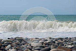 The Sea Wave of the Black Sea is a pebble beach. Smooth horizon, blue sky.