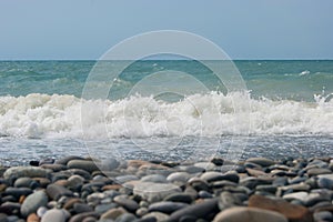 The Sea Wave of the Black Sea is a pebble beach. Smooth horizon, blue sky