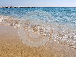 Sea wave breaking on beach in Barcelona, Spain