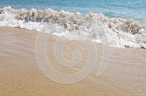 Sea wave breaking on beach in Barcelona, Spain