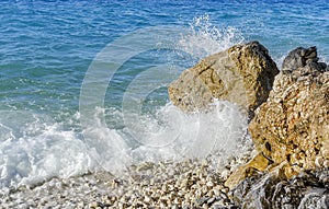 Sea wave is broken about stones.