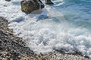 Sea wave is broken about stones.