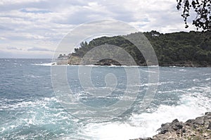 The sea wave crashing on the rock and make the splashing water and white air foam bubble.