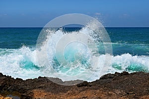 Sea wave crashing on rocks