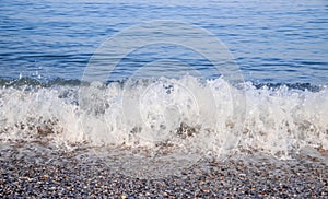 Sea wave in the morning light. Sea wave and beach. Sea wave background. Crimea. Wave and pebble beach. Rest and travel to the sea