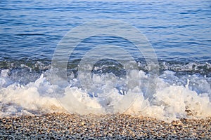 Sea wave in the morning light. Sea wave and beach. Sea wave background. Crimea. Wave and pebble beach. Rest and travel to the sea