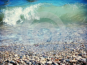 Sea wave runs onto a pebble beach