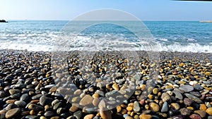 Sea wave runs over the shore. a pebble beach. the concept of a summer holiday by the water