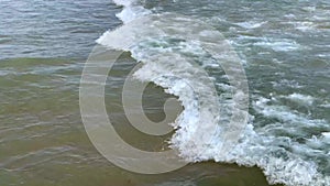 Sea wave on the shore, white breakers on the wave