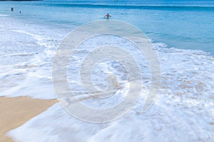 The sea wave splay white foam on the beach