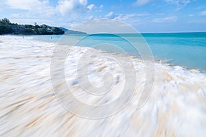 The sea wave splay white foam on the beach