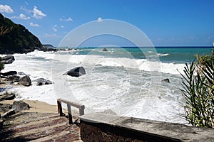 Sea waves bouncing onto shore creating shower of water droplets