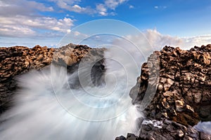 Sea waves breaking on rocks