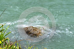 Sea waves breaking on a rocks. Deep blue sea waves hit cliff