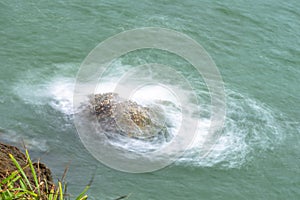 Sea waves breaking on a rocks. Deep blue sea waves hit cliff