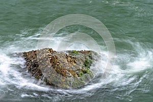 Sea waves breaking on a rocks. Deep blue sea waves hit cliff