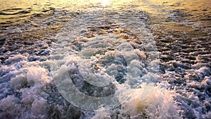 Sea Waves Bubbles and Sunset Behind Ferryboat