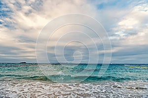 Sea waves on cloudy sky in philipsburg, sint maarten. Seascape and sky with clouds, white cloudscape. Beach vacation at