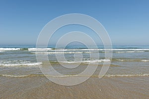 Sea waves coming ashore on the beach photo