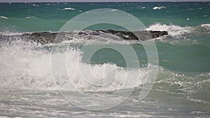 Sea waves crashing on a rock