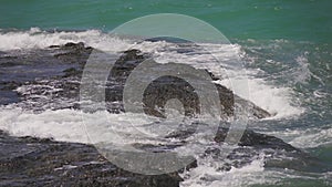 Sea waves crashing on a rock