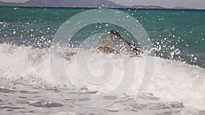 Sea waves crashing on a rock
