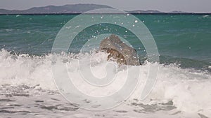 Sea waves crashing on a rock