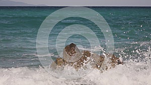 Sea waves crashing on a rock