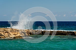 Sea waves crashing on rock during storm