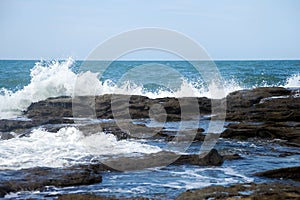 Sea waves crashing into rocks