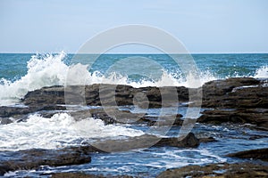 Sea waves crashing into rocks photo