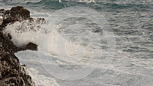 sea waves crushing over rocks with soft light
