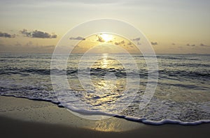 Sea waves that hit the beach Background clouds and Golden light of sunrise in the morning on the sky at Thung Wua Laen Beach  ,