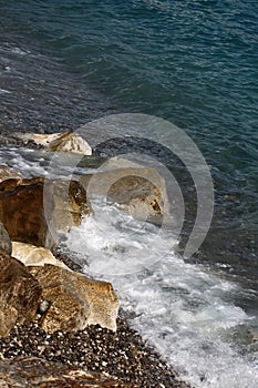 Sea waves hit stony seashore