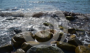 Sea waves lapping on rocky coast