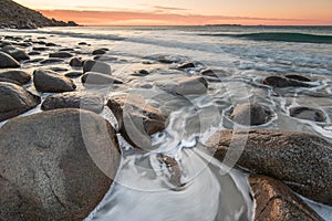 Sea waves lash line impact rock on the beach