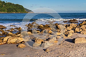 Sea waves lash line impact rock on the beach