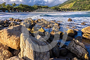 Sea waves lash line impact rock on the beach