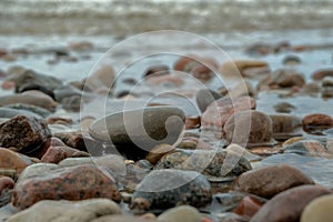 Sea waves lash line impact rock on the beach