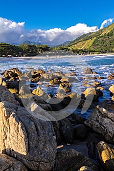 Sea waves lash line impact rock on the beach